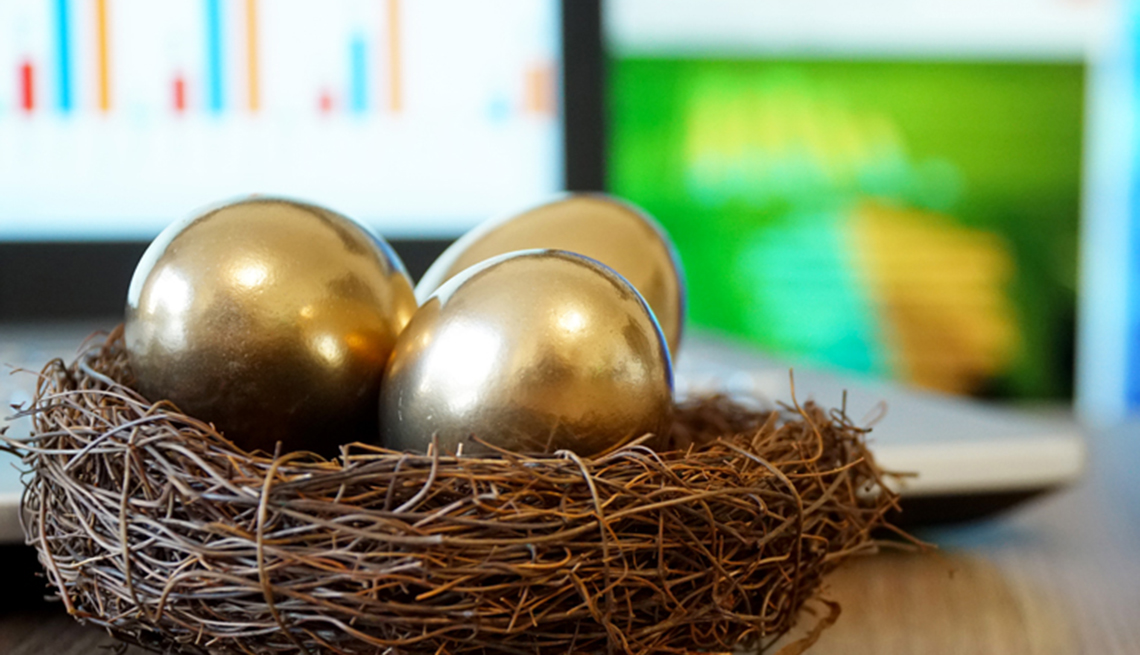 three golden eggs in a nest with online planning charts in background