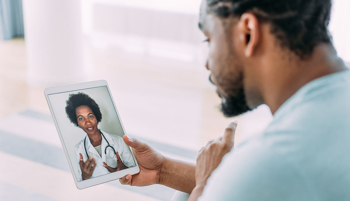 Shot of a patient talking to a doctor using digital tablet, telemedicine concept