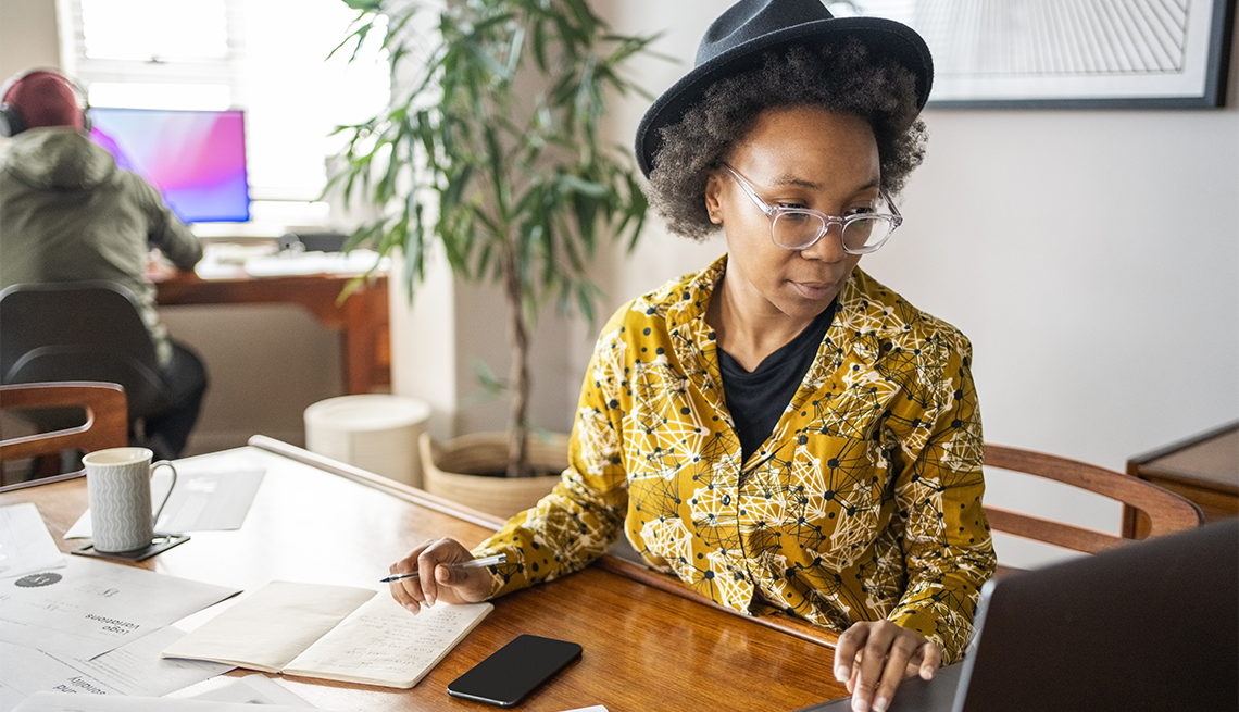 woman writing a story on her laptop