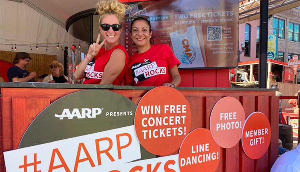Two women smiling in an a a r p rocks event booth