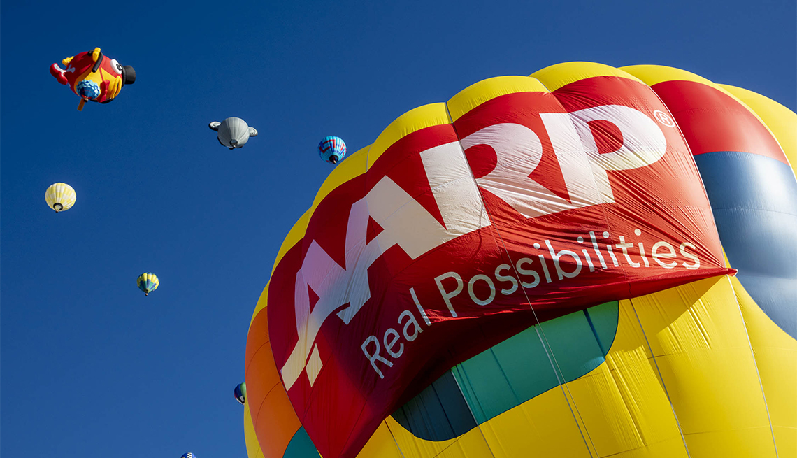 a hot air balloon in the sky with words a a r p real possibilities written on it