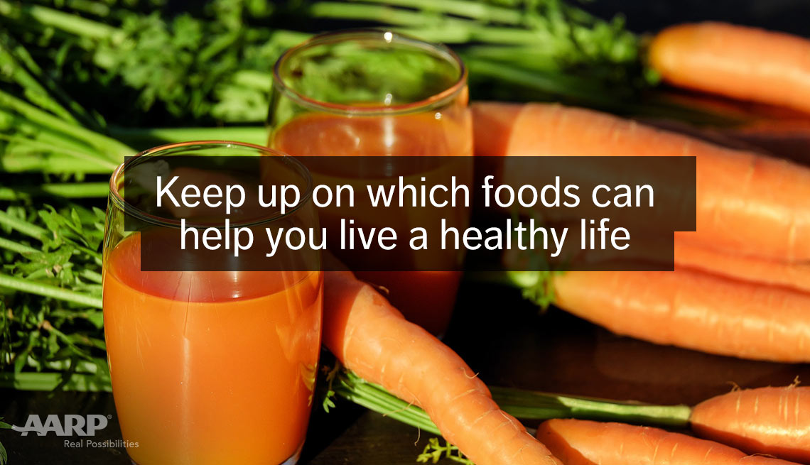 Glasses of carrot juice, fresh carrots. Keep up on which foods can help you live a healthy life