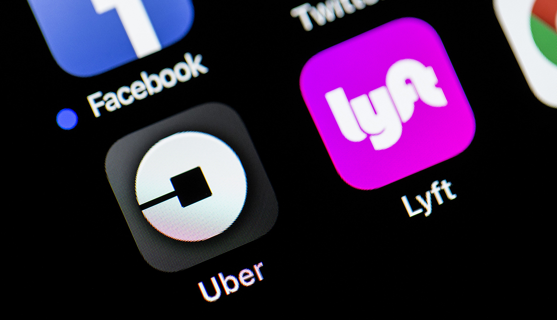 Uber and Lyft icons on a smartphone