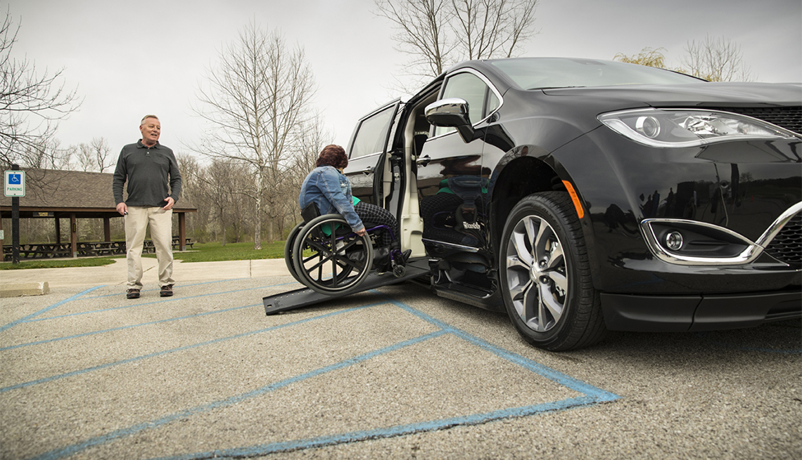 item 5 of Gallery image - woman rolls her wheelchair adapted by BraunAbility into a Chrysler Pacifica