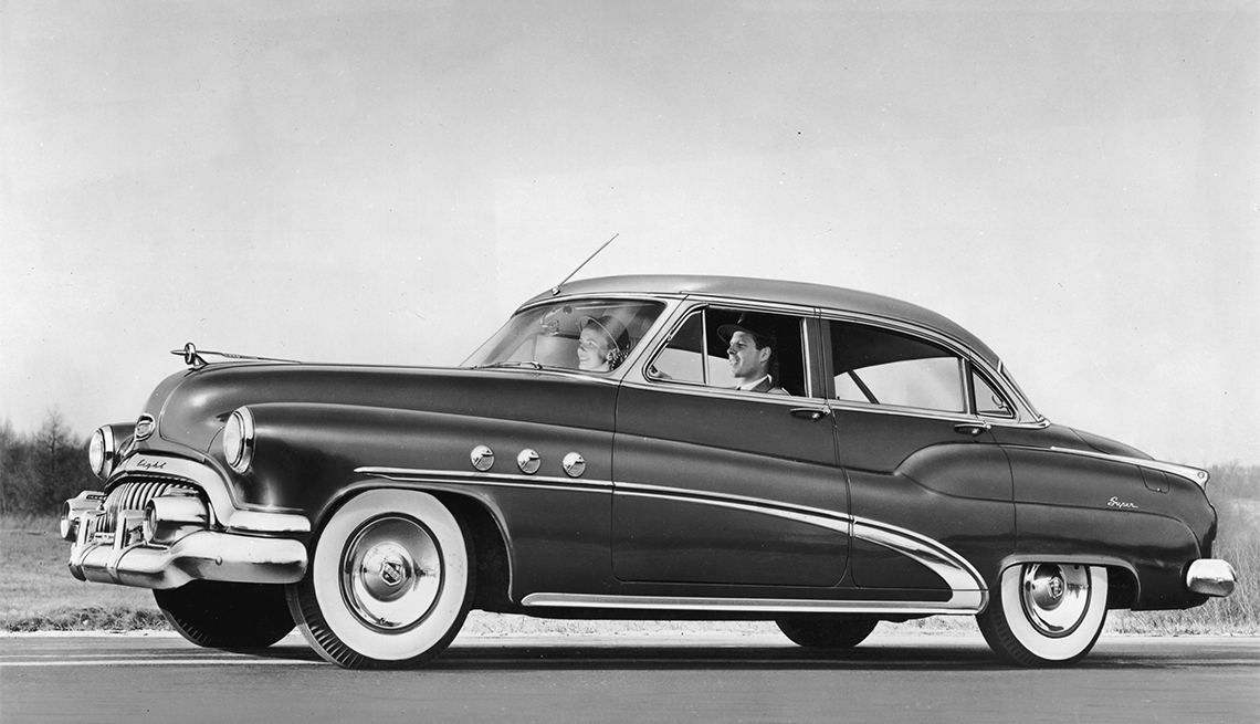 couple driving a 1952 Buick Super Riviera four-door Sedan 
