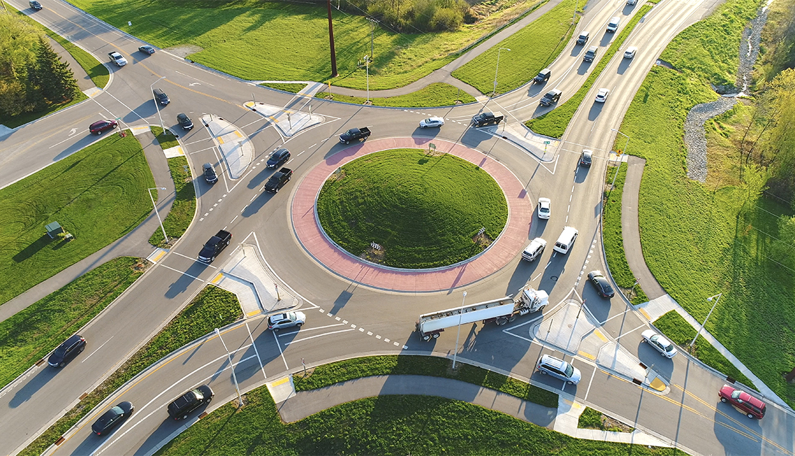 aerial view of a busy city roundabout intersection at sunrise rush hour