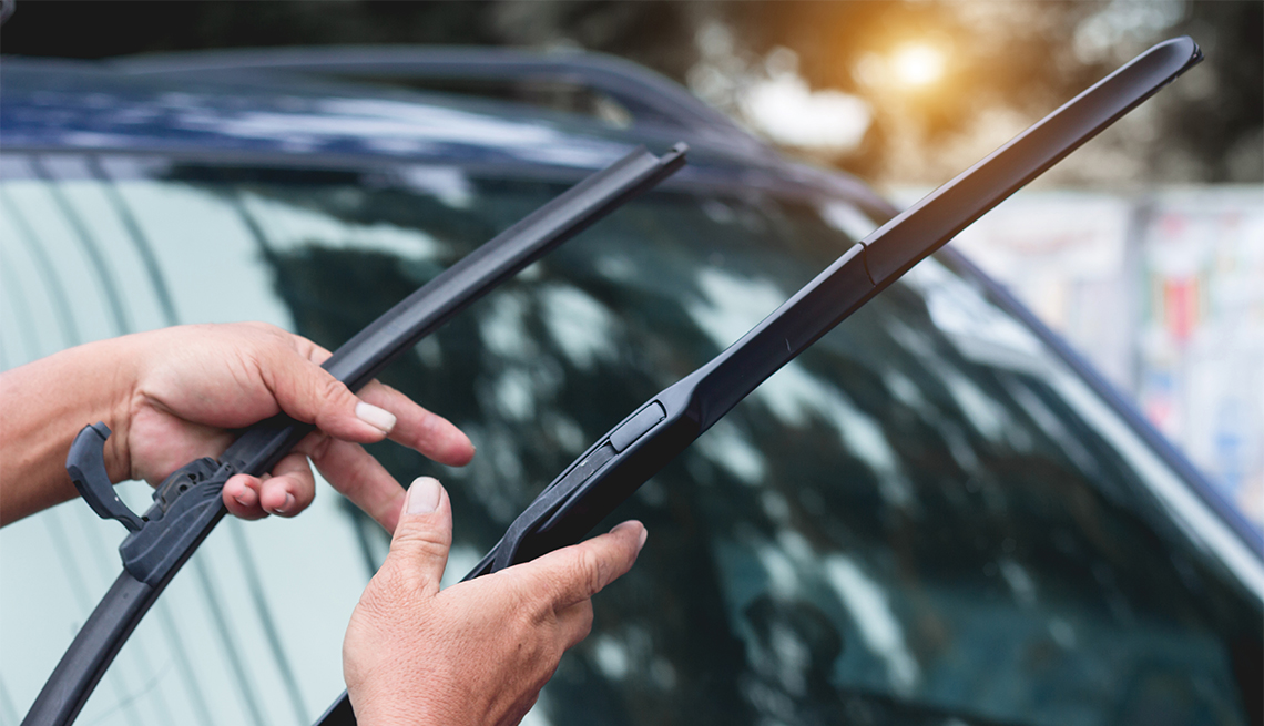 person checking windshield wiper blades