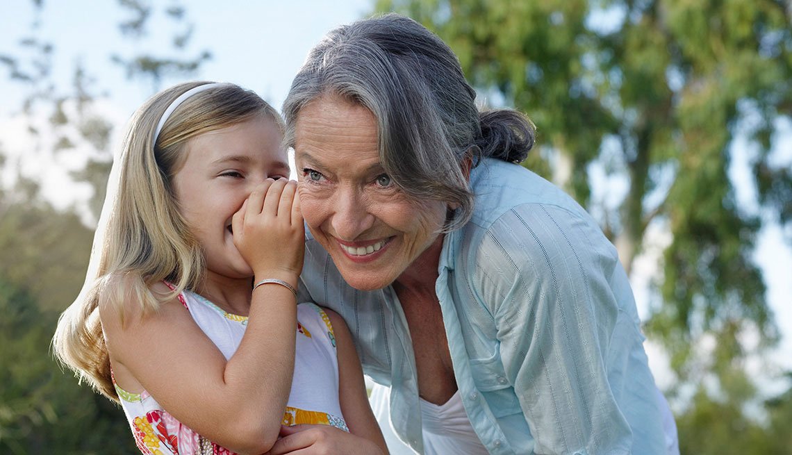 young girl whispering in grandmother's ear, Hearing Program