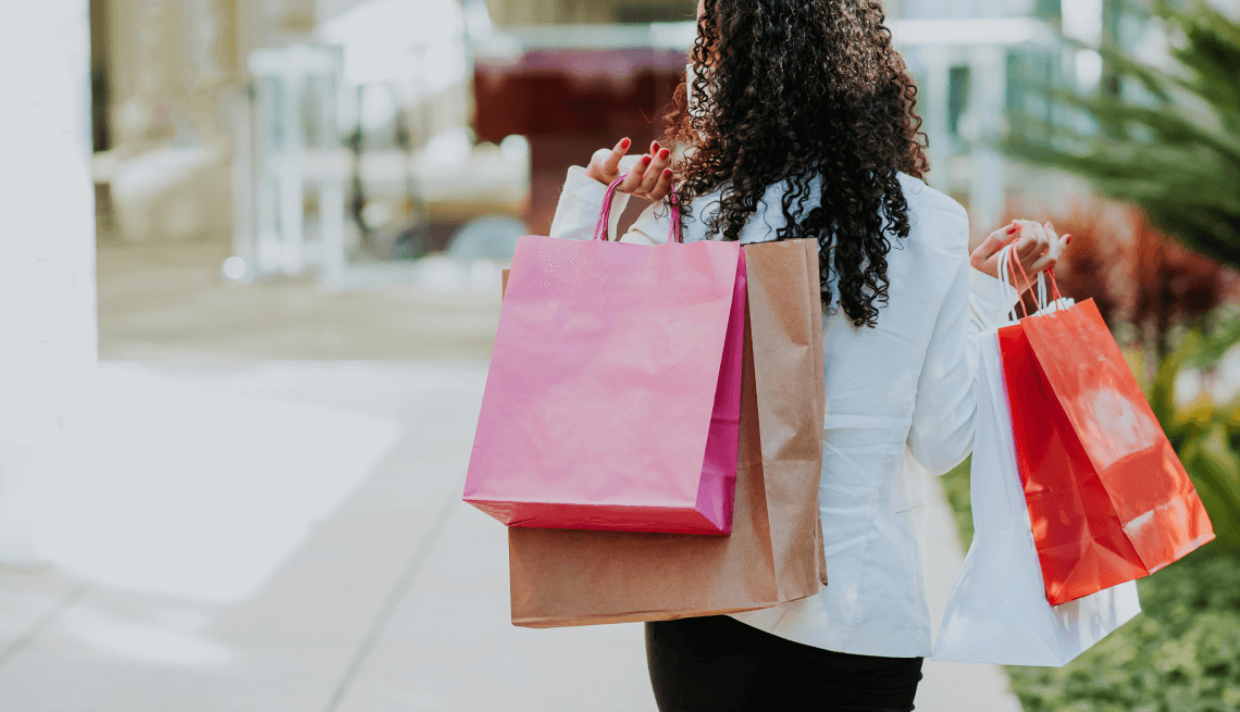 woman holding multiple shopping bags