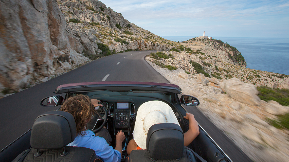 Couple in convertible on road trip in Spain