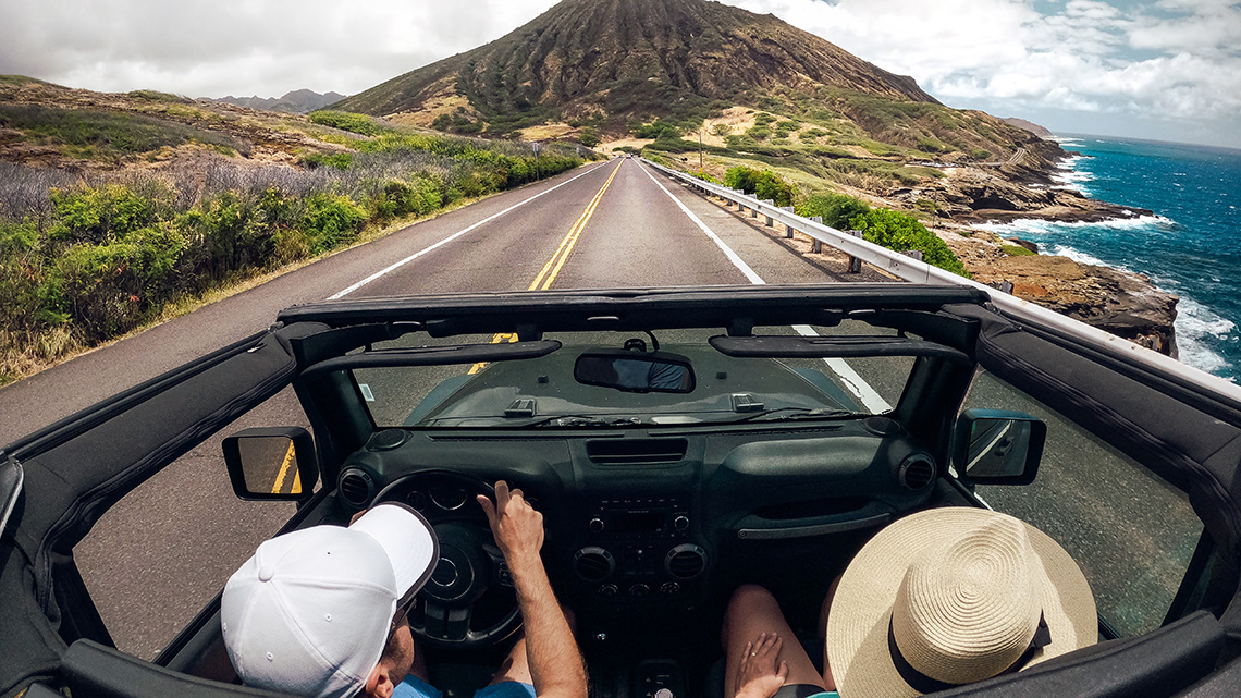 Rear view of a couple driving a convertible car, Lahaina, Maui, Hawaii, USA