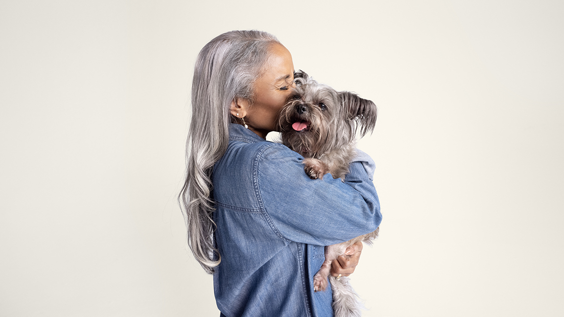 Senior woman hugging a dog