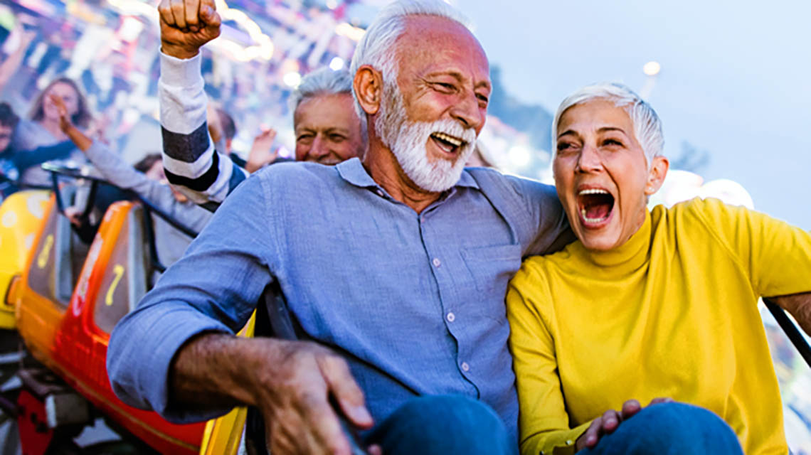 A senior couple on a roller coaster ride