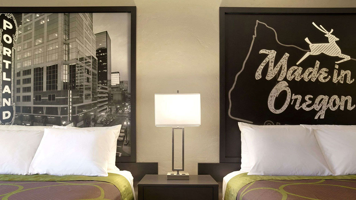 Interior view of double beds and  nightstand at Super 8 property