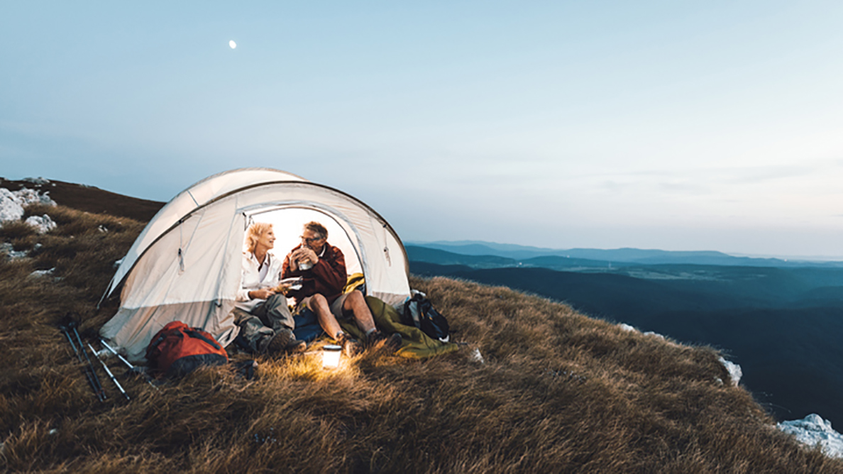 Couple tent mountainside eating