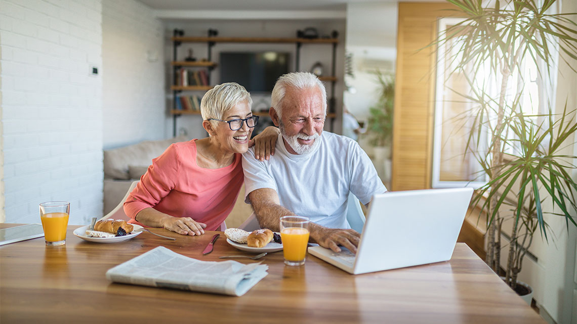 Senior couple shopping online from their home