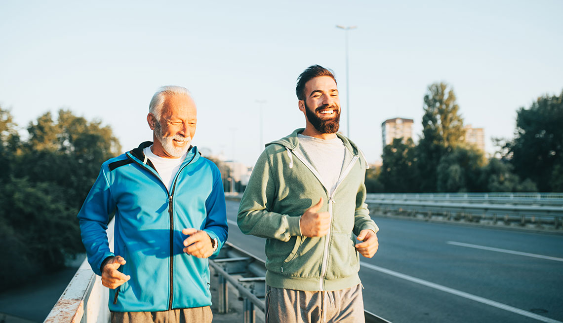 two men younger older jogging side by side outside