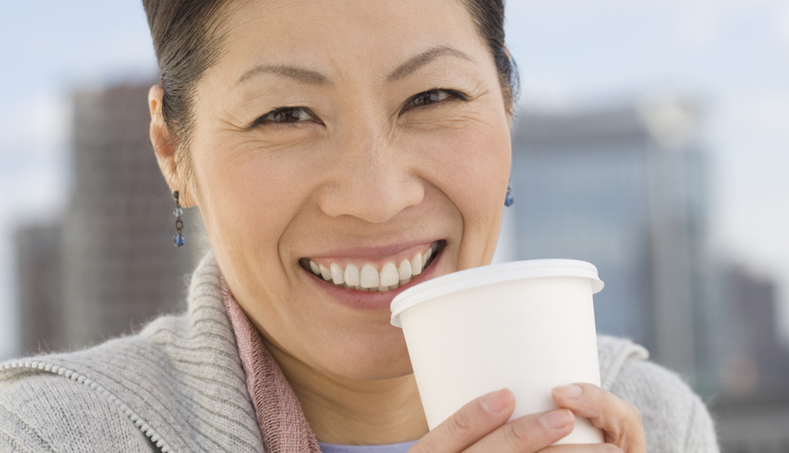 Woman drinking out of cup