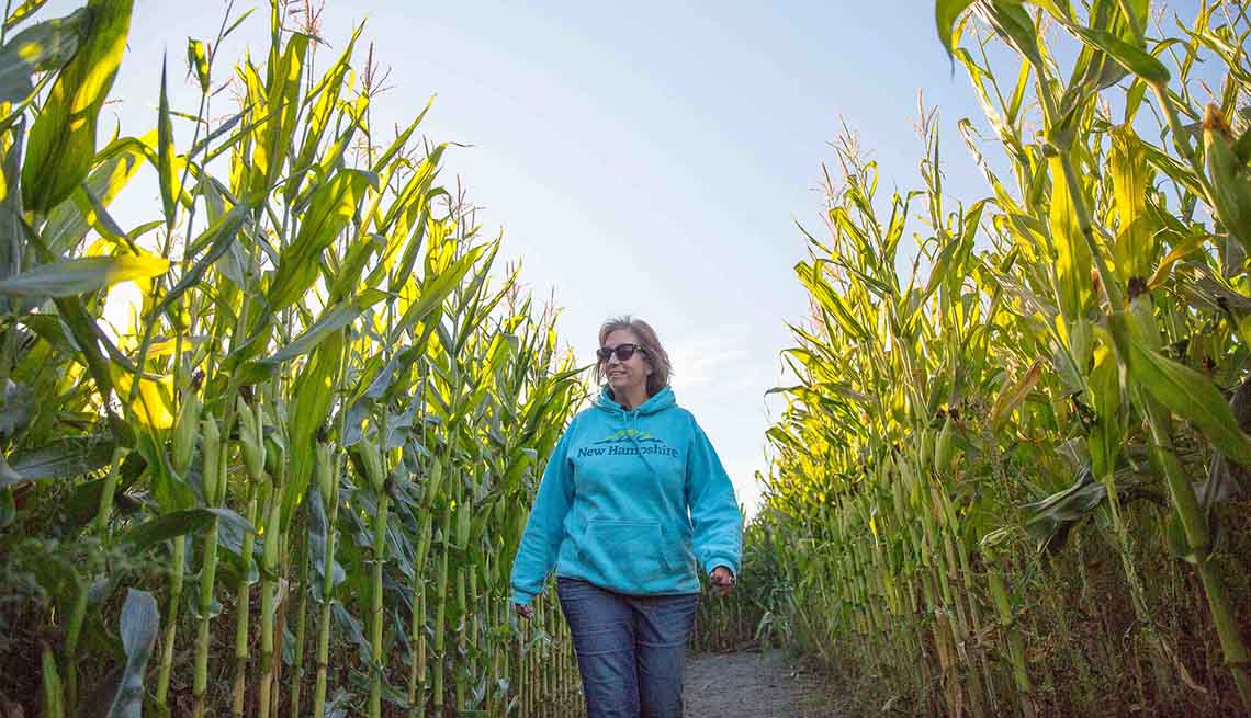 item 4 of Gallery image - A woman walking through a corn field