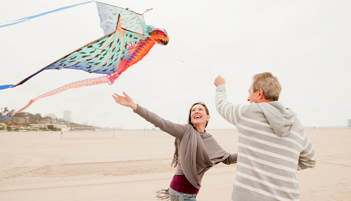 Couple flying a kite on the beach