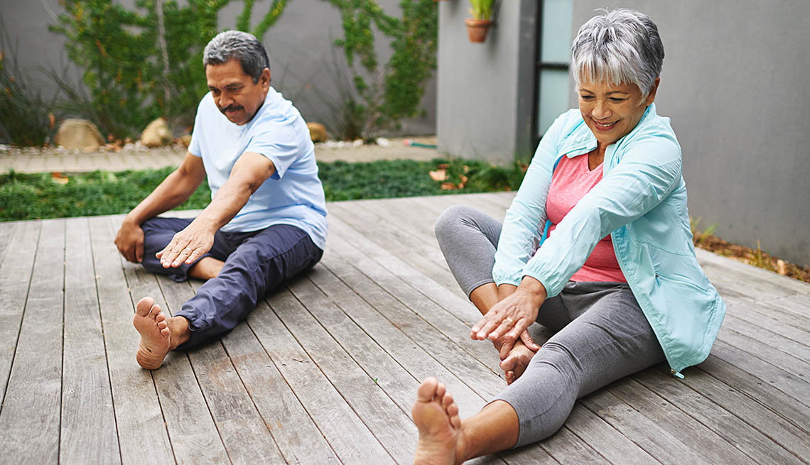 Shot of a happy older couple practicing yoga together outdoors