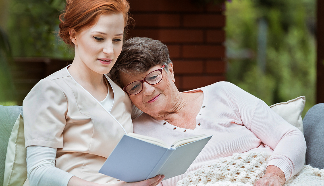 mature mother and daughter read a book 