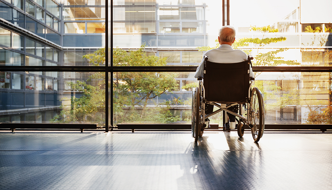 Mature male at a nursing home facility looking out the window