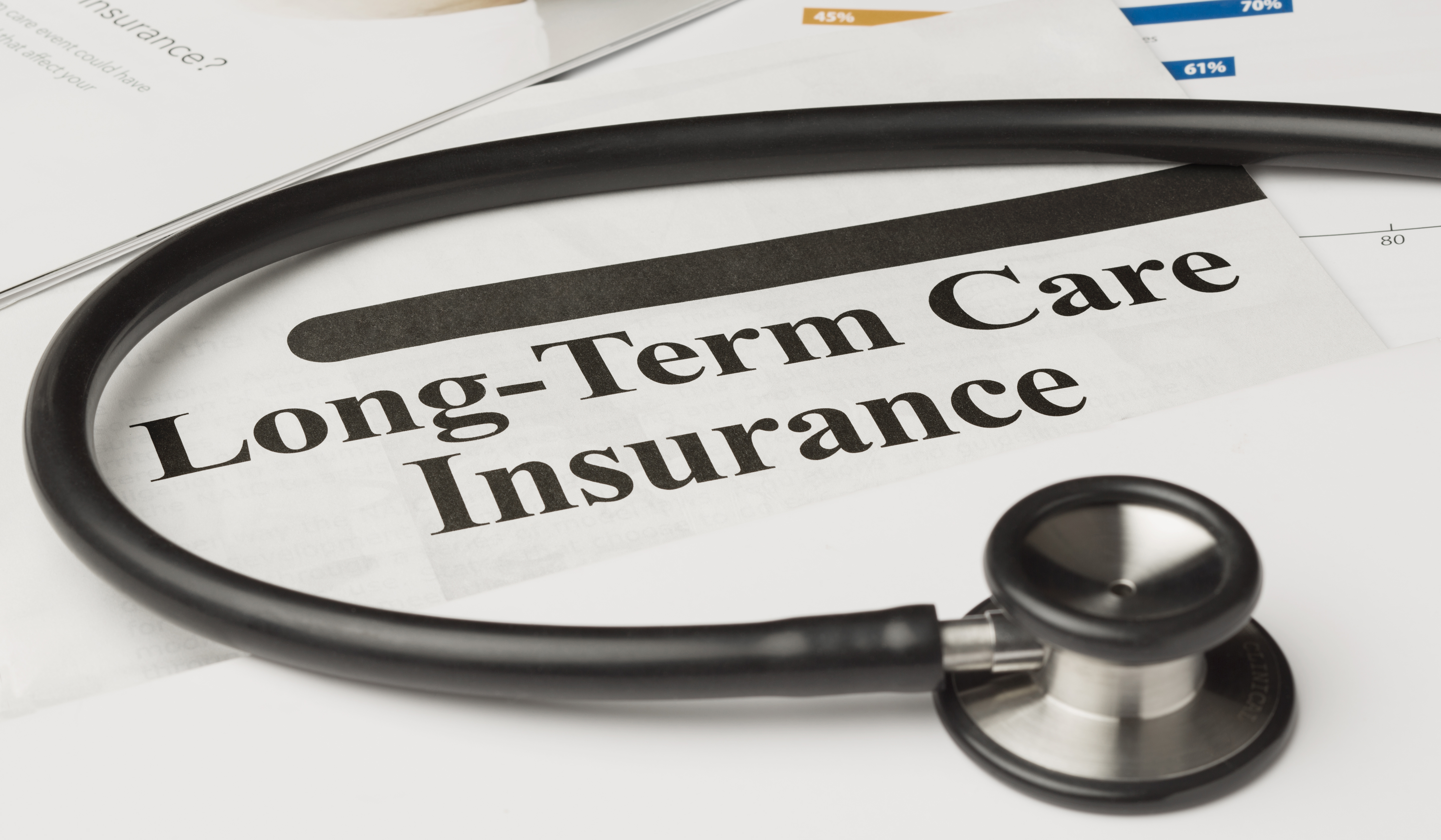 Long-term care insurance information, form and stethoscope.  