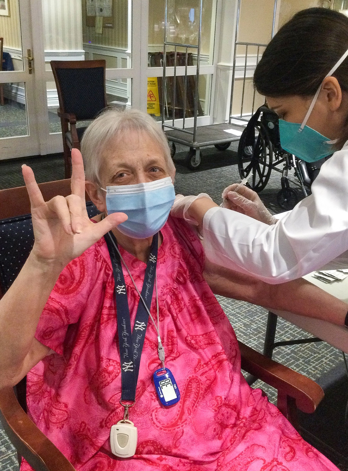 nursing home resident receiving a covid vaccine shot