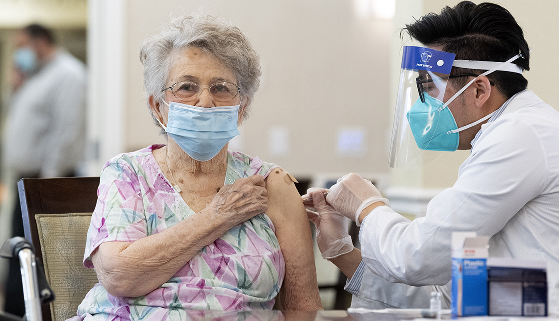 Un farmacéutico de CVS administra la vacuna Pfizer / BioNTech COVID-19 a un residente de la comunidad de ancianos de Emerald Court en Anaheim, California.