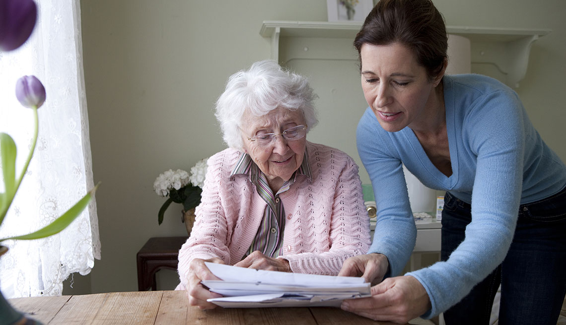 woman being shown paperwork by daughter