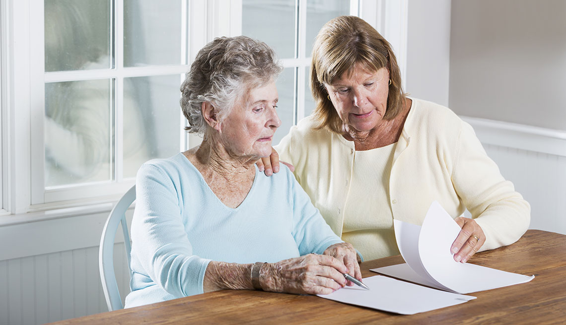 family caregiver helping her mother with legal documents