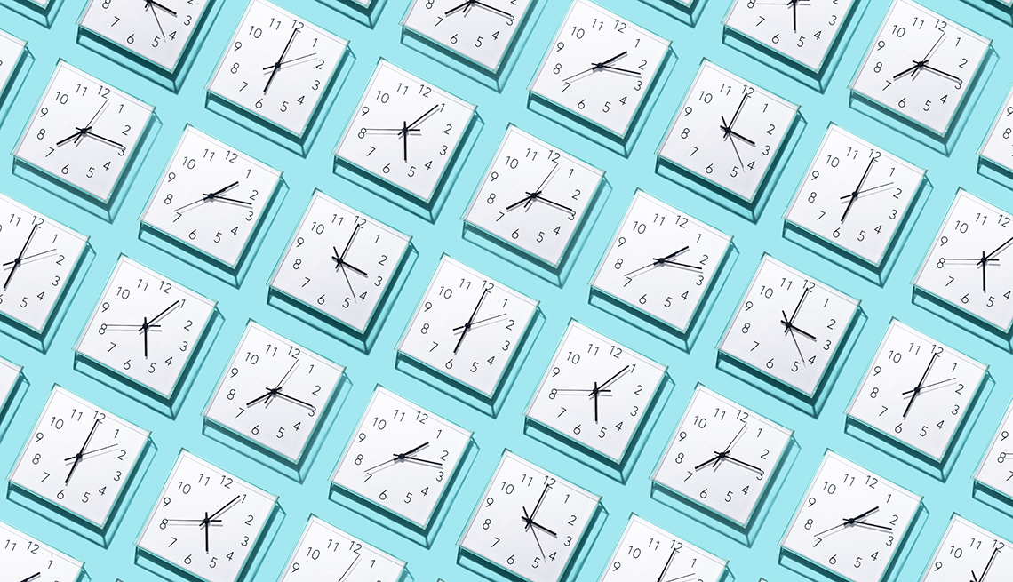 rows of white wall clocks all showing different times on a light blue background