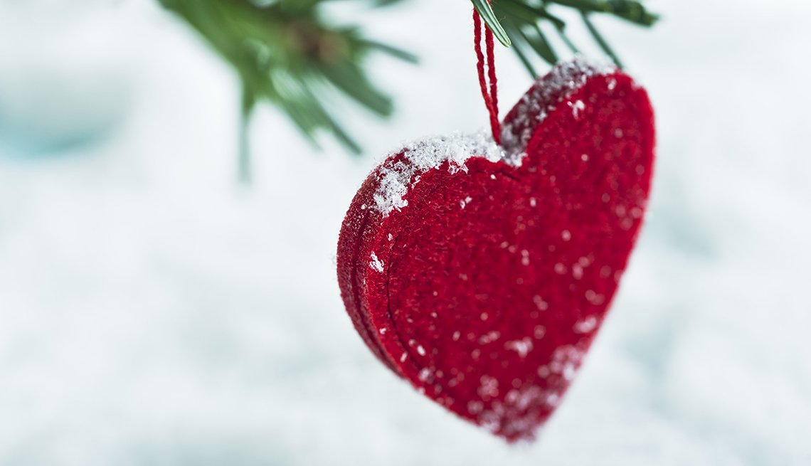 Snow on a red heart ornament 