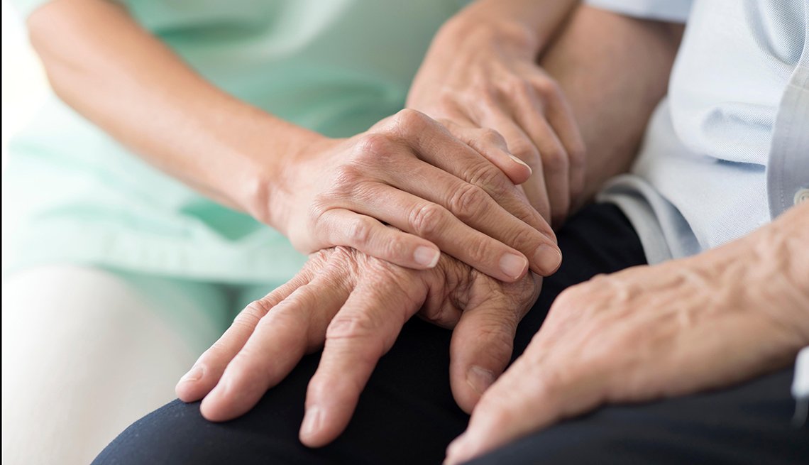 Worker holds man's hands