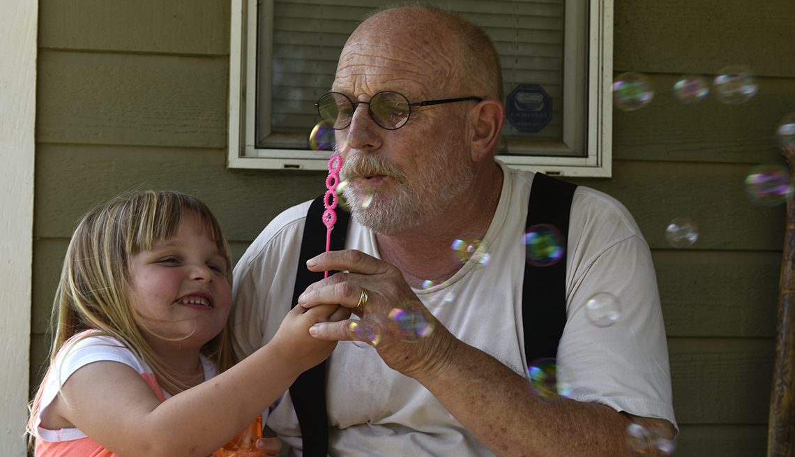 item 3 of Gallery image - Grandfather and grandchildren blow bubbles, opioid crissis