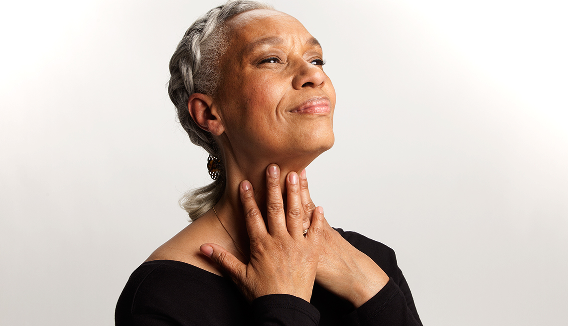 Woman with hands on her neck doing Face Yoga