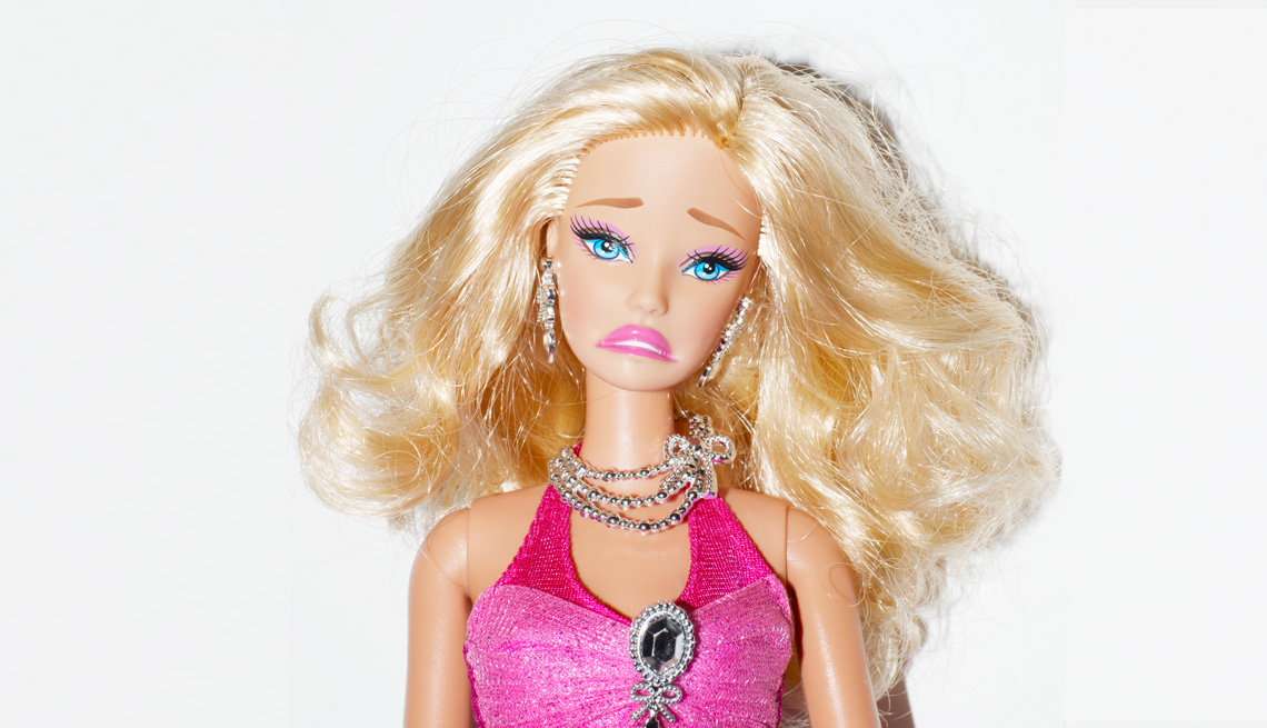 Barbie-type doll with a frown on her face