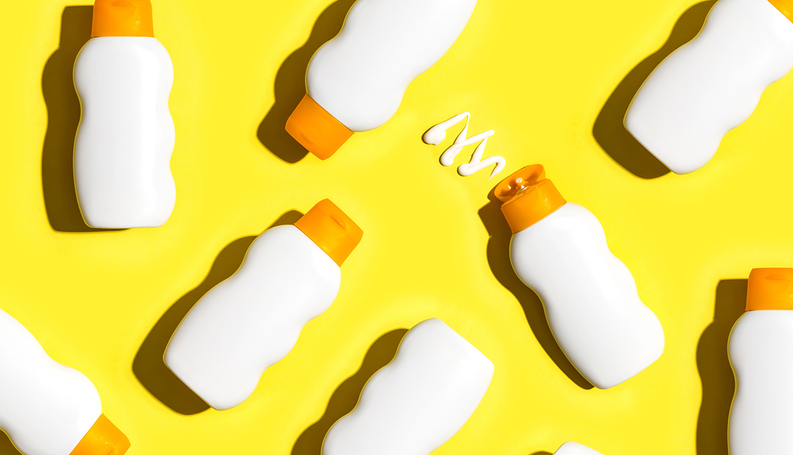 Sunscreen bottles arranged on a bright yellow background
