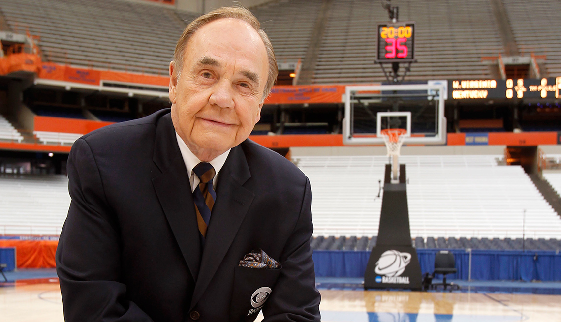 Dick Enberg poses for a portrait on a basketball court