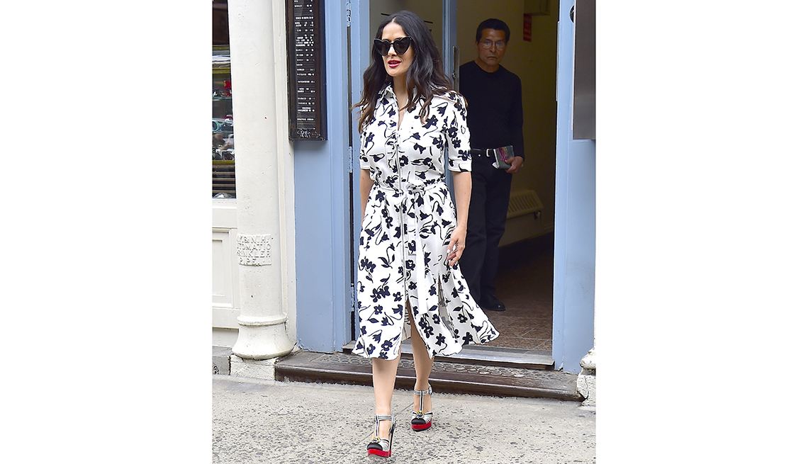 item 10 of Gallery image - salma hayek walks out a door wearing sunglasses and a printed dress