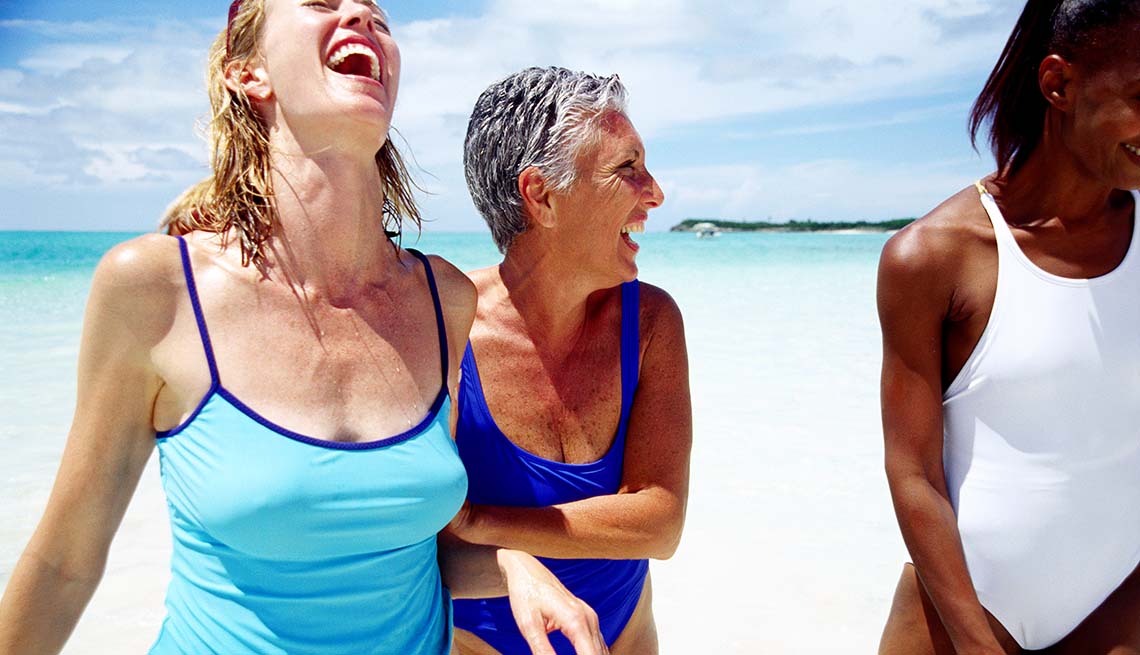 3 women frolic at the beach