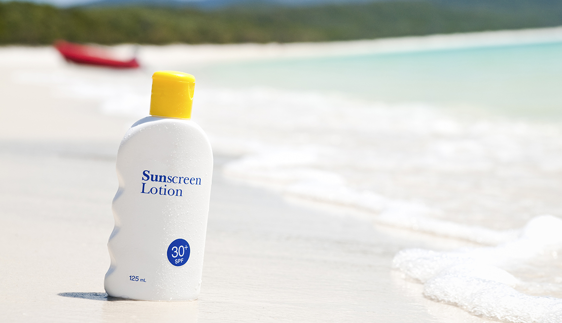 item 2 of Gallery image - A bottle of sunscreen lotion on the sand at the beach nearby the ocean