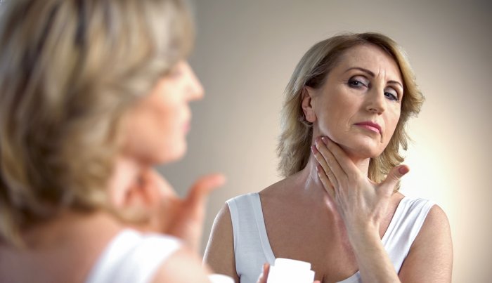item 10 of Gallery image A woman applying cream on her neck