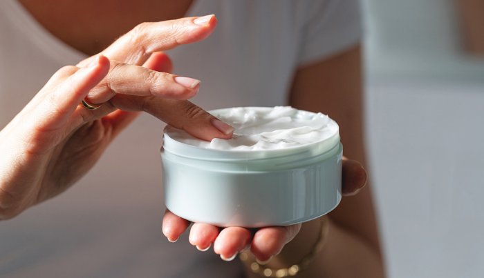 item 10 of Gallery image A close-up of woman's hands holding moisturizing cream jar