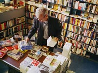 Man searching through books at a bookstore