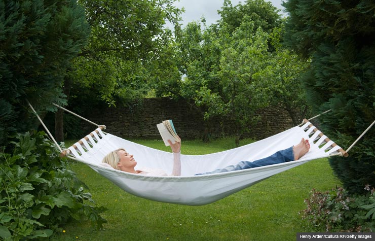 Woman reading book in hammock, Summer Book Recommendations (Henry Arden/Cultura RF/Getty Images)