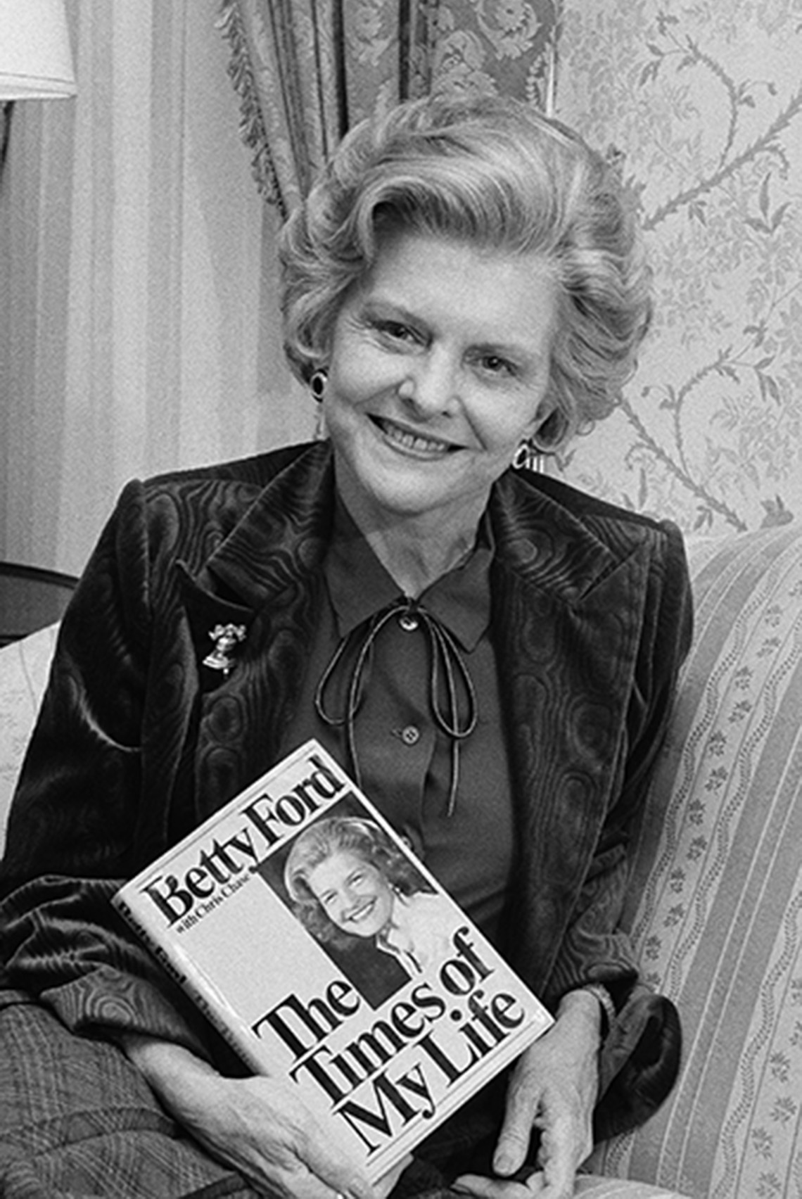 Betty Ford holding her book