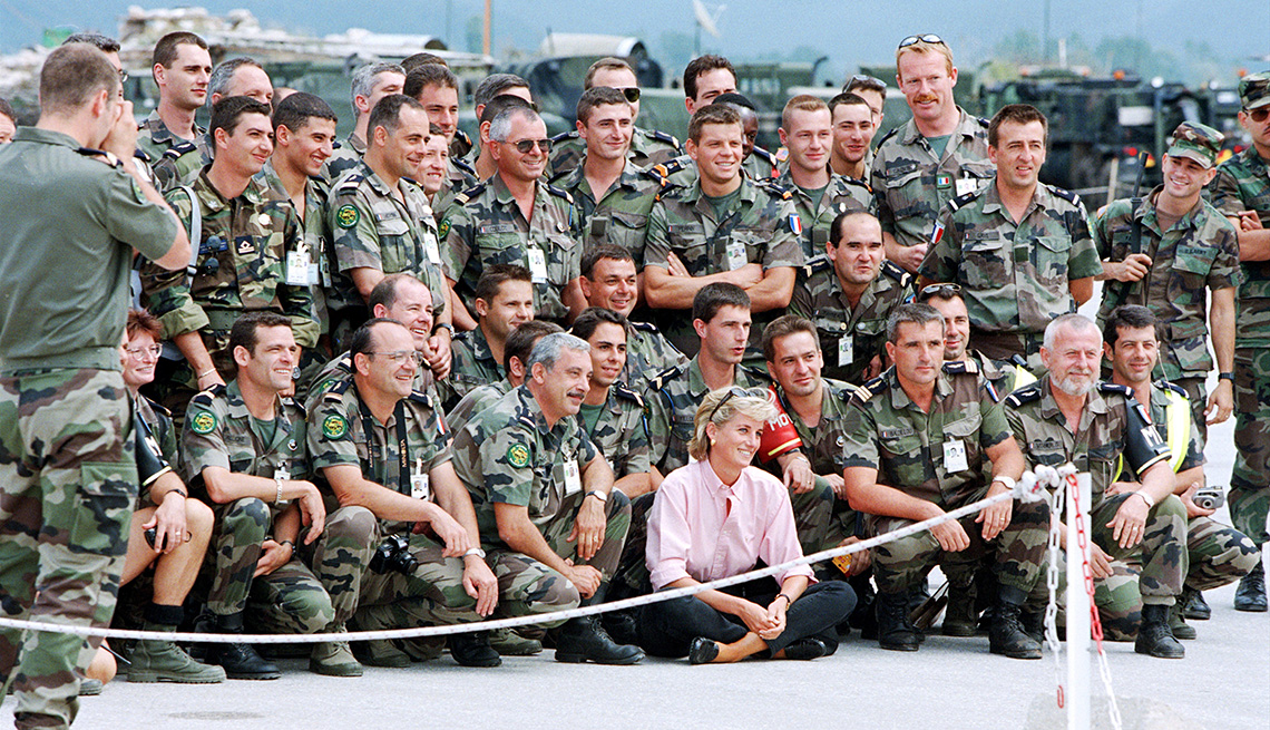 item 9 of Gallery image - Diana, Princess of Wales, posing for a photograph with some French SFOR soldiers at Sarajevo airport before her flight to London