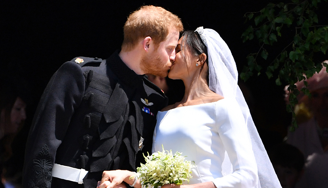 item 2 of Gallery image - Prince Harry, Duke of Sussex kisses his wife Meghan, Duchess of Sussex as they hold hands.